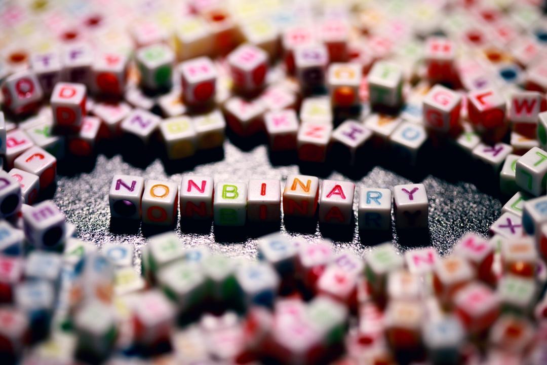 "nonbinary" escrito com dados de letras coloridas